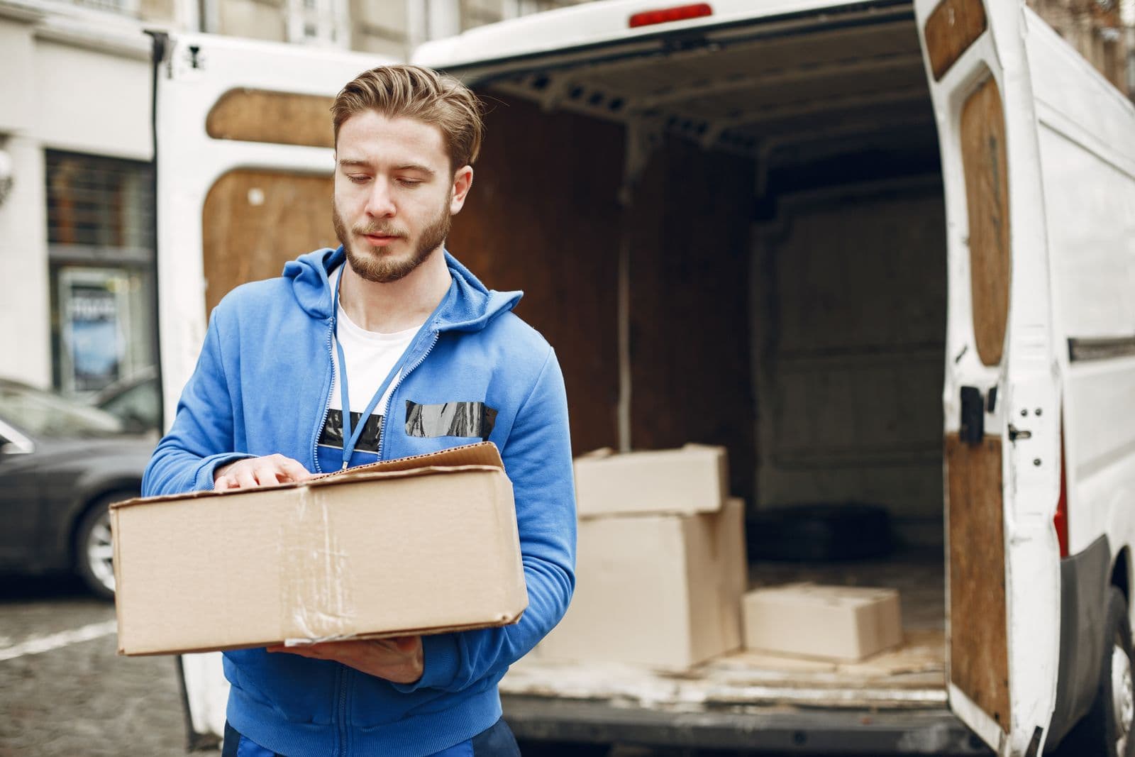 Moving crew loading a Unishore truck outside a residential building