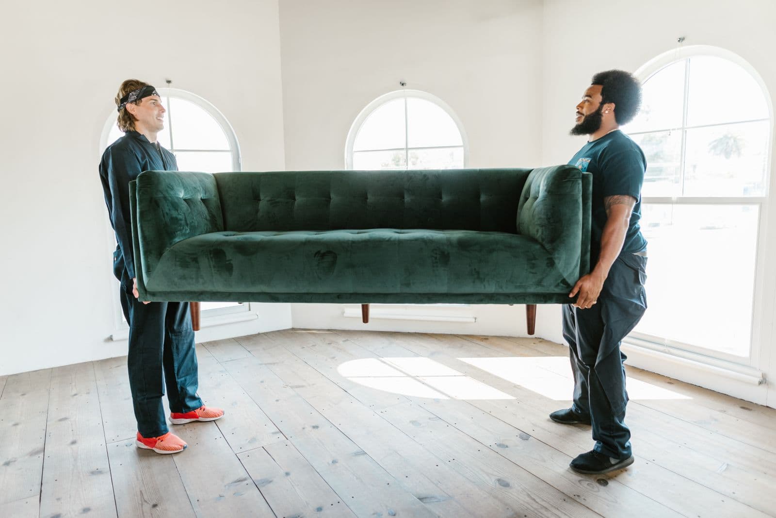 Team carrying furniture into a bright new office space