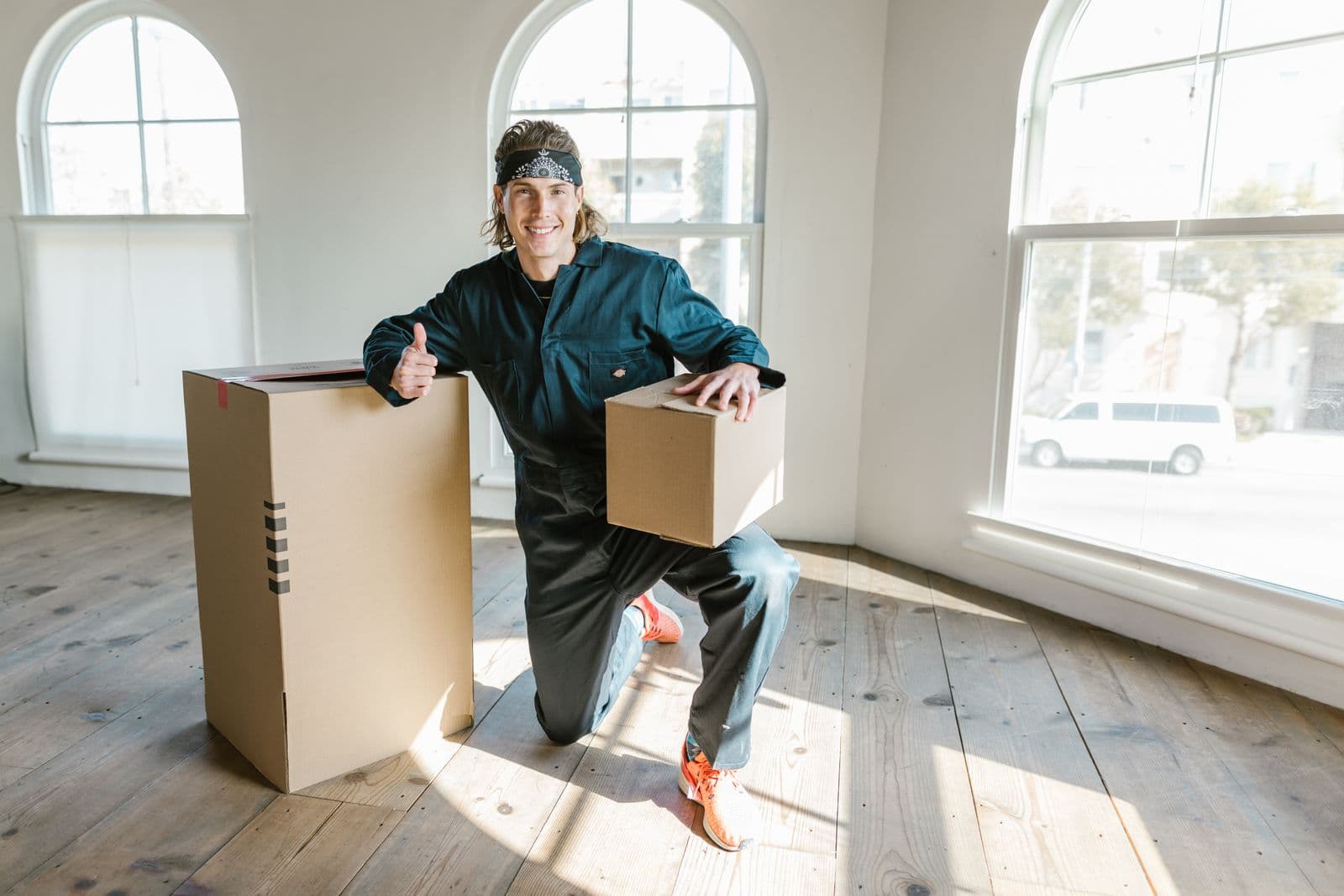 Mover wrapping furniture before loading it onto a truck
