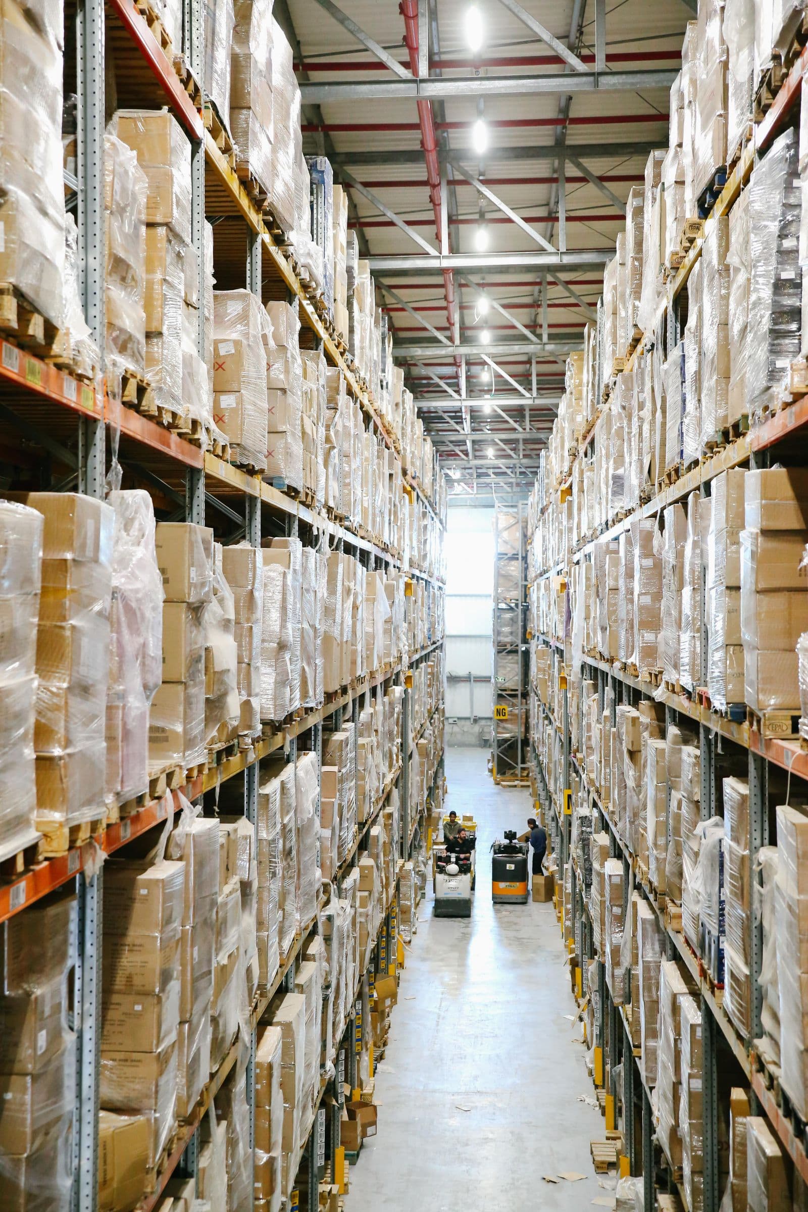 Labelled moving boxes stacked neatly on warehouse shelving